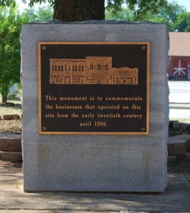 West Church Street Monument. Text reads: "This monument s to commemorate the businesses that operated on this site from the early twentieth century until 1986."