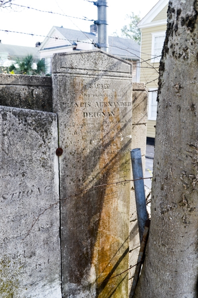 Tombstones line the wall behind the church. Image taken in 2014 by R&R