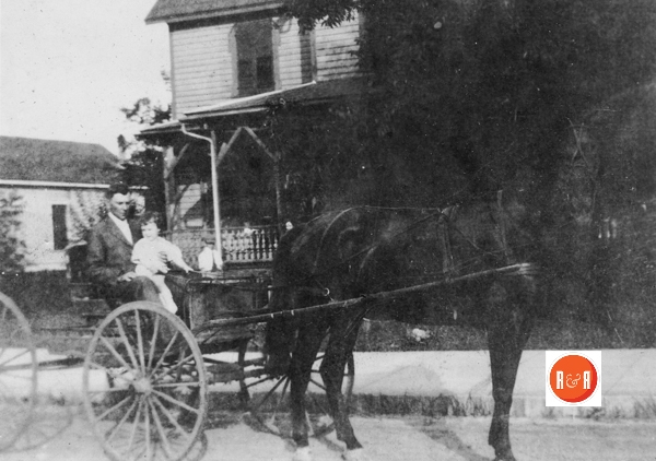 Mr. R.M. Cross in his buggy in the front of the home.