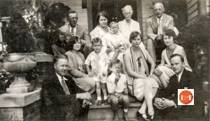 Family Gathering in 1928 – We believe this to be the only complete photo of the entire McKinnell family at the time it was taken on the front porch of their home at 178 Columbia St. The photo includes Mr. & Mrs. McKinnell, their 5 children, a son-in-law, a daughter-in-law and 3 grandchildren. Back row L to R – John Edward Norris Sr. – his wife Mary Watson McKinnell Norris holding their son William Manly Norris – Mary Craik McKinnell & William McKinnell Sr. Middle row L to R – Mildred Emery McKinnell, wife of John Craik McKinnell Sr. & their son John Craik McKinnell Jr. – Jennie Craik McKinnell – Isabel Elliott McKinnell. Front row L to R – John Craik McKinnell Sr. – John Edward Norris Jr. – William McKinnell Jr.