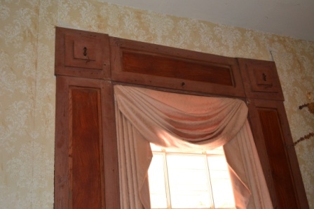 Heavy Empire style casings surround the door and window openings of the parlor at Cedarhurst.