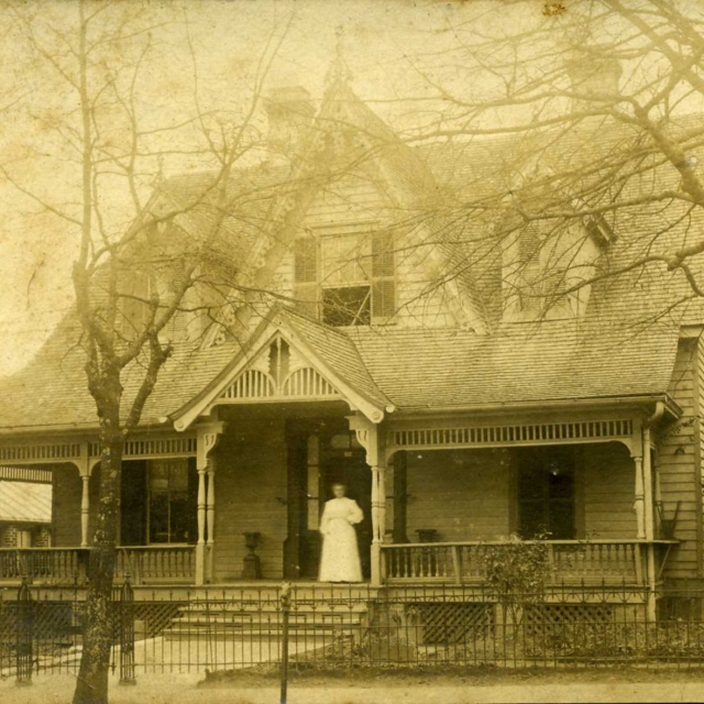 Mills house on East Main Street, Rock Hill, SC – Mrs. Arnold Friedheim standing on the front porch.