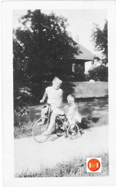 Helen and George Moore (tricycle) in front of the Albert Henry home at 188 Columbia Street