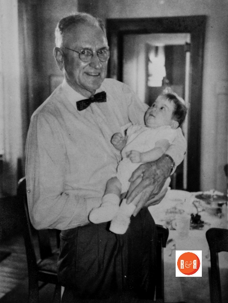 Albert Torbit Henry holding one of the grandchildren.