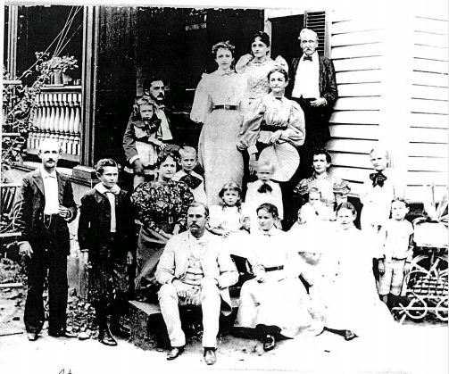 Members of the Aiken Family on the side porch of their home.