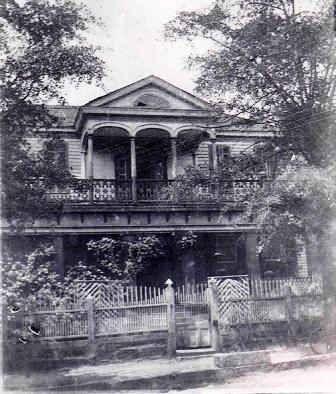 This home appears to have originally featured a double porch very similar to that of the Wolfe house. Later the elaborate ironwork gallery was added to the front of the Aiken home.