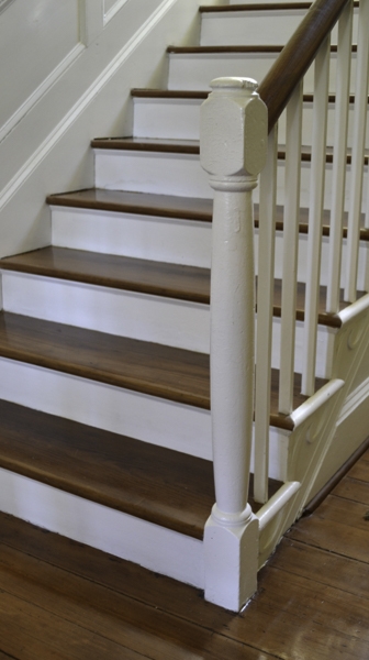 The staircase features outstanding carpentry and trim work along each riser.