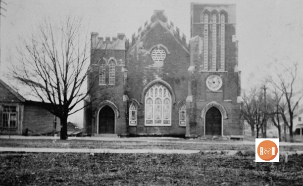 The Methodist Church was constructed using red brick which were found to be too porous and therefore the church was stuccoed for preservation. This image was taken by local photographer Van Center shortly after the church was completed. The building to its left, was the store of the Beaty family.