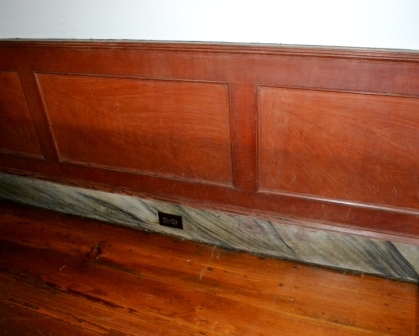 Original grain painted wainscoting at the stage coach house.