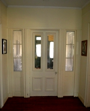 The original rear door of the home is now in the center of the house.