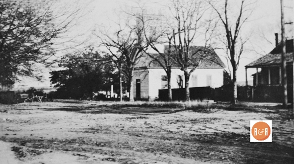 View of East Washington Street showing the edge of the Carlisle house and the original location of the Methodist Church. Image reportedly taken in circa 1912. Courtesy of the Van Center Collection