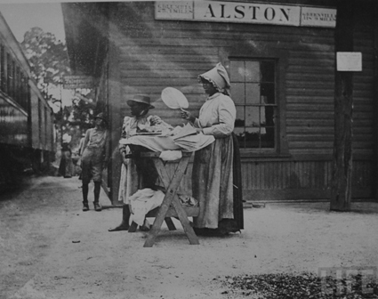 Ladies selling food and other items to train workman and passengers at the Alston Depot.