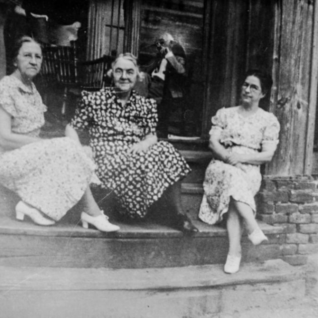 Cousin Leila Steel, and Lula Blain Hicklin, Janie Blain Hammiter, (both were sisters of my grandfather John Melville Blaine, Sr.) and Rev. Hammiter sitting on the porch of the house.