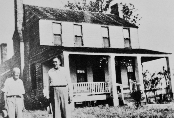 Standing in front of the William C. Cauthen house are W.L. Phillips and Claude Bell (rt). Built in 1848, the house is representative of the antebellum upcountry S.C. farm style. Pine wood was used throughout.  There are two chimneys and five hearts.  Many of the glass panes are original. A small barn of hand hewn logs is nearby, and a chicken house constructed before 1895 survives.  The house, which is located on Highway 521 between Heath Spring and Kershaw, was placed on the NR in Aug. of 1982.  Photo courtesy of the Lancaster Co Historic Preservation Committee.