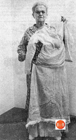 Eva Shell Martin, a 1915 graduate of Lander College, displays her graduation dress.