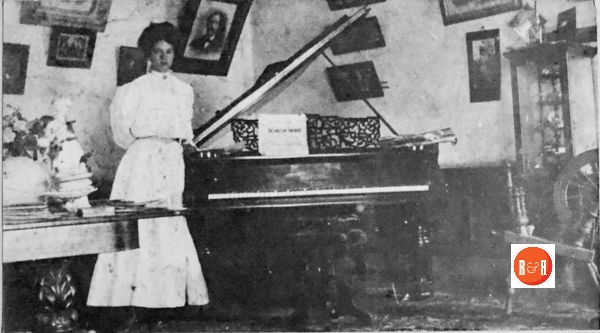 Parlor at Mt. Shoals, Enoree, S.C., summer of 1900. Faye Hill at her grand piano, sheet music – “The Lord is My Sheperd”.  She was a well known pianist in S.C.  Note the manner of which the pictures are hung in the “Rustic Style” of the period.  Coleman – Meek Collection.