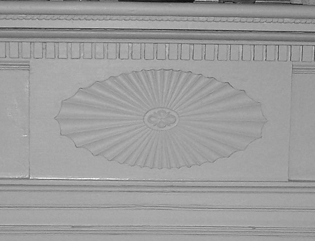 The fine carving on the parlor mantel is one of many features taken from an early 19th century architectural pattern book.