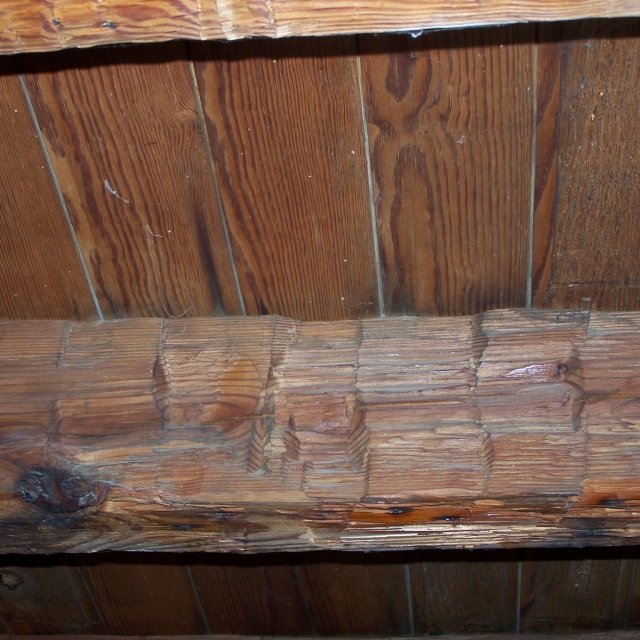 Rough hewn finish of the early 19th century ceiling beams. These beams were originally covered with T&G ceiling boards.