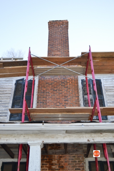 Re-pointing the bricks in the two story chimney is part of the restoration work in 2014.