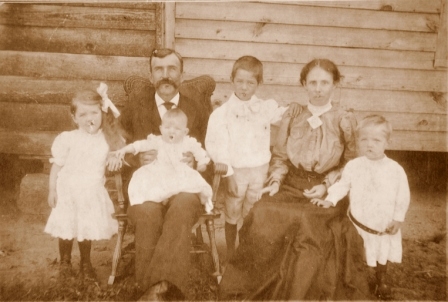James N. Russell family, the son of the Rev. R.Y. Russell. Pictures with him is his wife, Barbara Chambers and thier children. The child on her father’s lap was Perry Smith Russell.