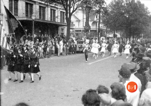 Parade image on East Main Street, in front of the Maxwell - Mayfield Furniture Company. Courtesy of the AFLLC Collection