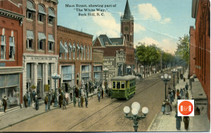 Trolley on East Main St., showing the location of the vacant lot which eventually became the location of the dime store. Image courtesy of the Turner Postcard Collection - 2012