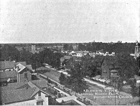 Birds eye view of the neighborhood taken from the tower of First Pres. Church. The Russell (#232 East Main Street) and McElwee homes (#224 East main Street), are on the left side of the image.