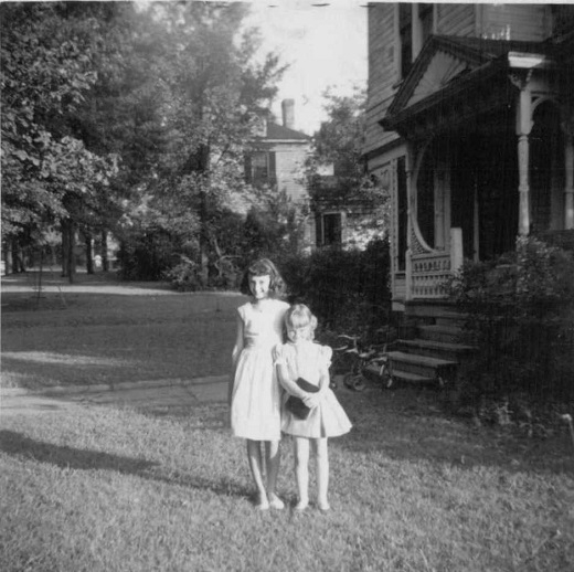 Ruth Burris with her cousin in the front yard of the old Frew home.
