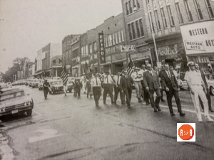 Mayor Dave Lyle walking in the downtown parade – showing the location of the Western Auto Store on East Main Street.