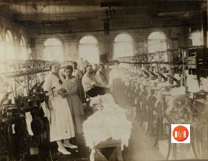 Yarn – spinning operation on the second floor of the brick structure at this address – circa 1915, pictured in this group is Ms. Bertha Wright.