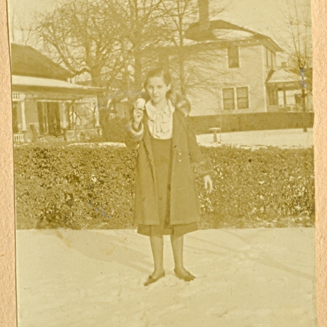 Thelma Givens on Hampton Street with the two story Hutchison home in the background.