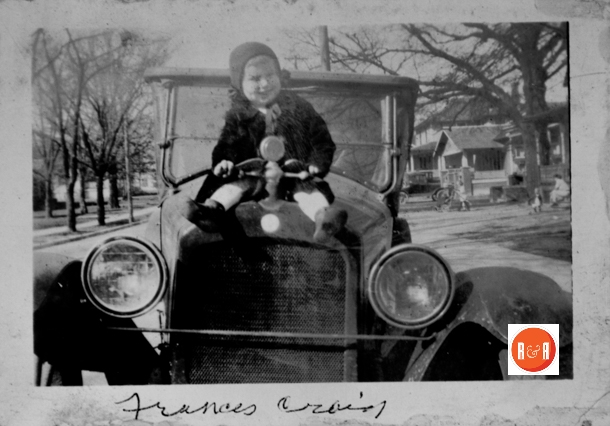 Frances Craig siting on her father’s car on Johnston Street.
