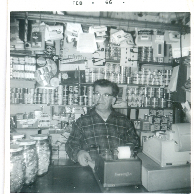 J.G. Moses behind the dry goods counter, 1966.