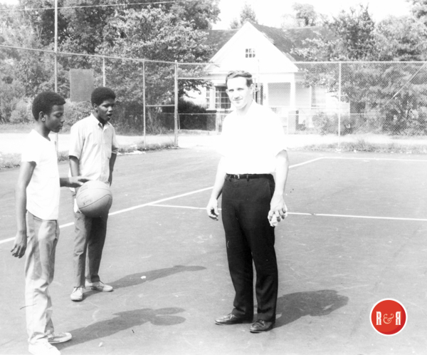Brother David Boone with students on the tennis courts.