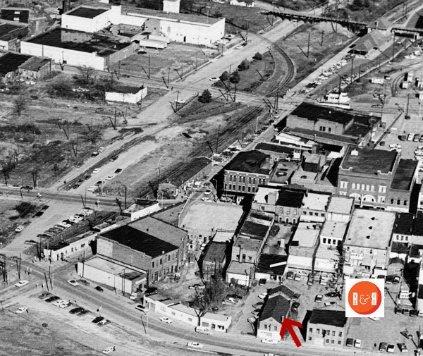 The hardware company’s warehouse was located just to the right of the Bishop Hall building (arrow), ca. 1970 image of downtown.  AFLLC Collection